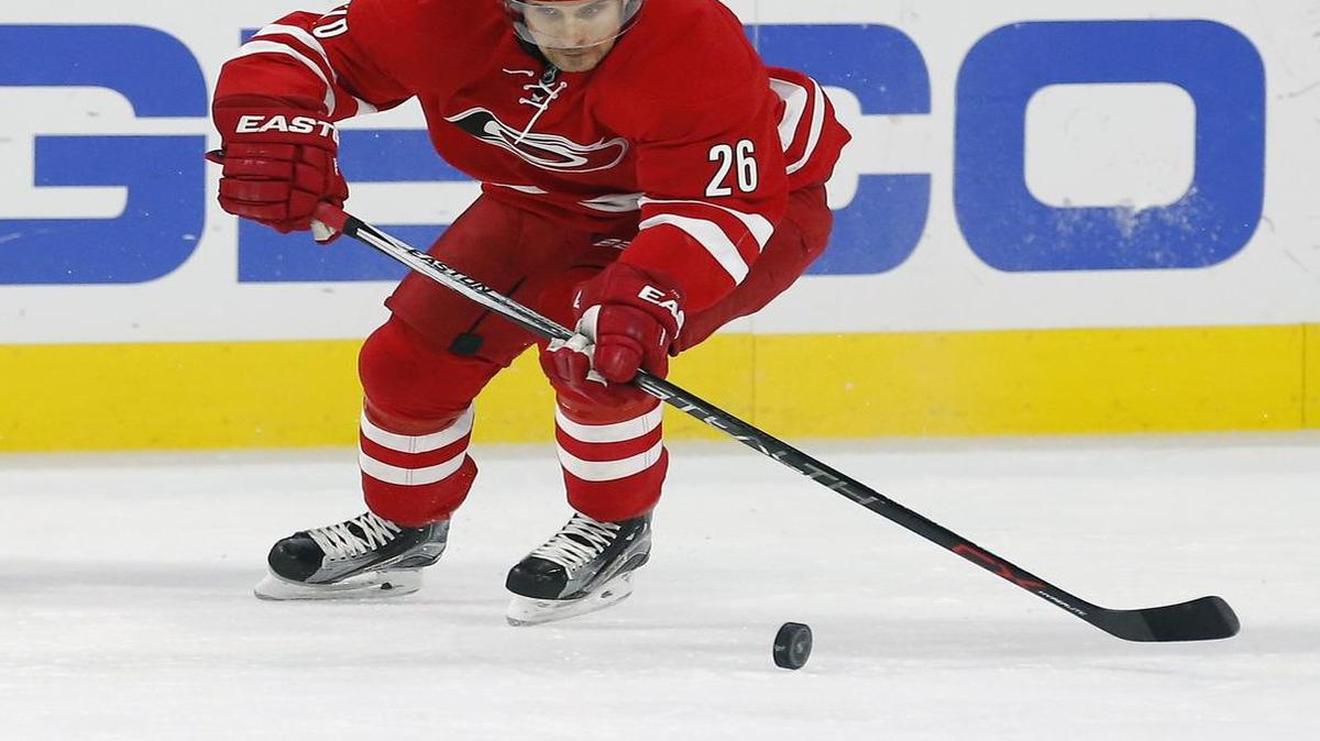 John-Michael Liles plays the puck against the Los Angeles Kings at PNC Arena on Nov. 22, 2015.