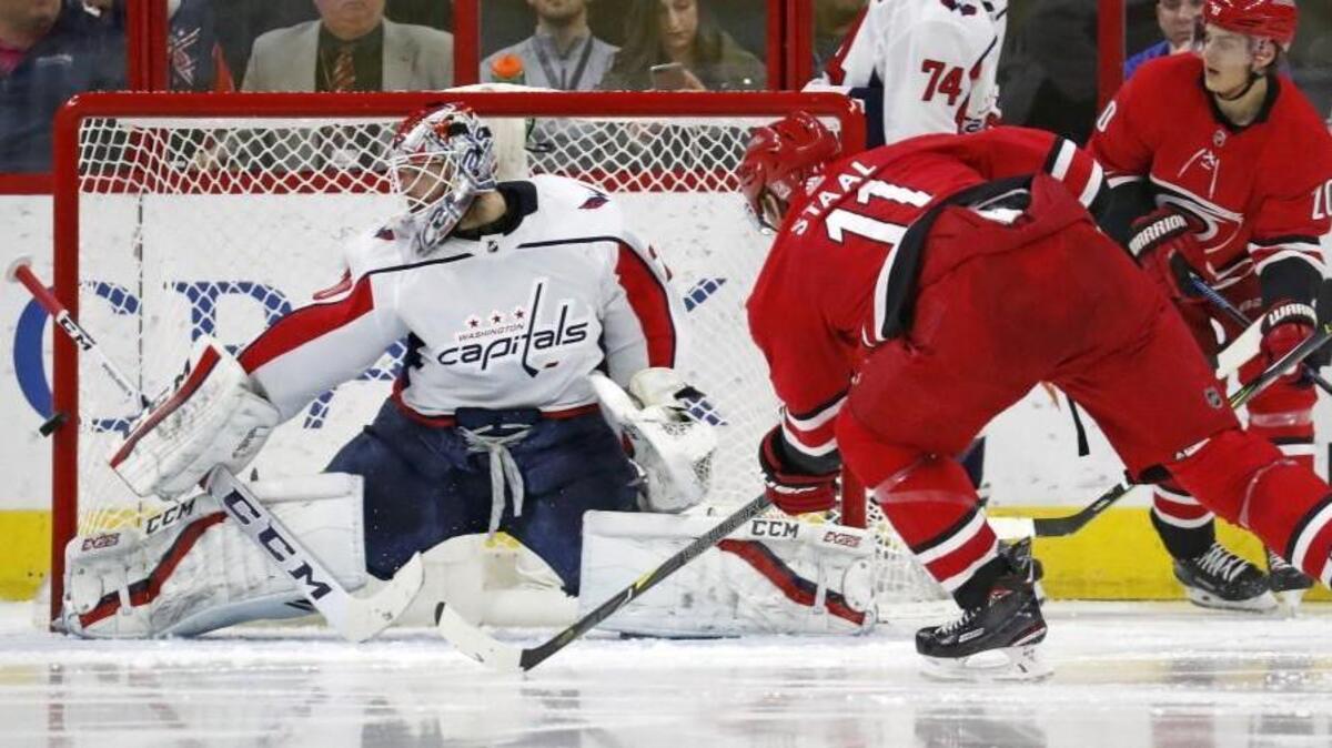 The Canes' Jordan Staal (11) shot bounces off the post as he shoots against the Caps' Braden Holtby (70) during the second period at PNC Arena on Jan. 2, 2018. The Caps beat the Canes 5-4 in overtime.