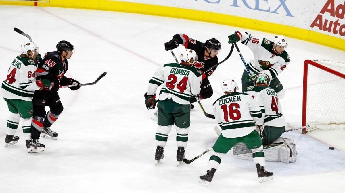 The Canes' Victor Rask (49) watches as his shot gets past Minnesota goalie Devan Dubnyk and the Wild defense for what proved to be the winning goal late in the third period at PNC Arena. Carolina’s Brock McGinn (23) is also in on the play.