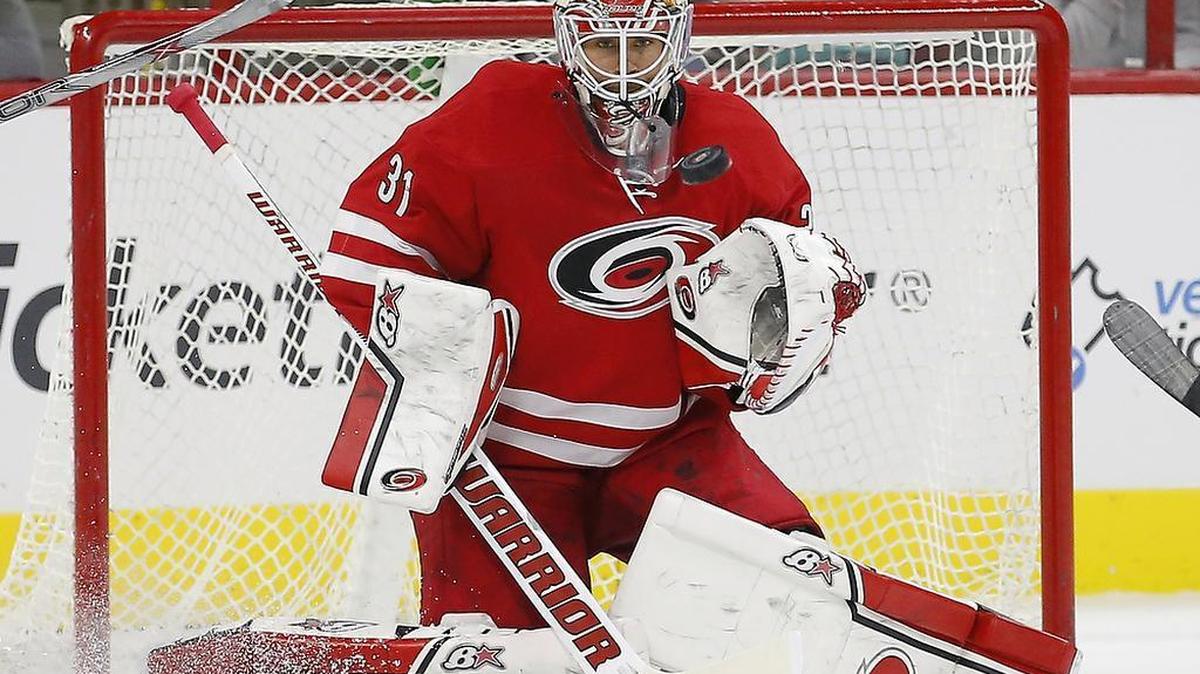 
The Carolina Hurricanes' Eddie Lack (31) keeps his eye on the puck as he makes a stop during the first period.
