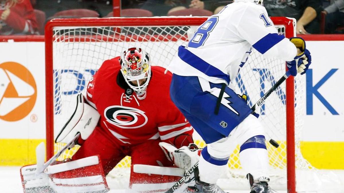 The Lightning’s Ondrej Palat (18) puts the game winning shot past the Canes’ Michael Leighton (32) during the overtime period of a preseason game at PNC Arena in Raleigh on Sept. 30, 2016.