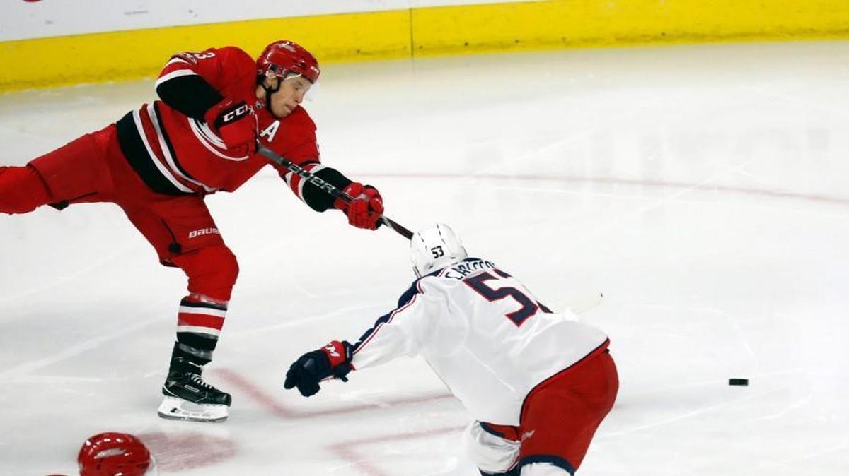 The Canes' Jeff Skinner (53) shoots against the Columbus Blue Jackets' Gabriel Carlsson (53) at PNC Arena in Raleigh on Oct. 10, 2017.