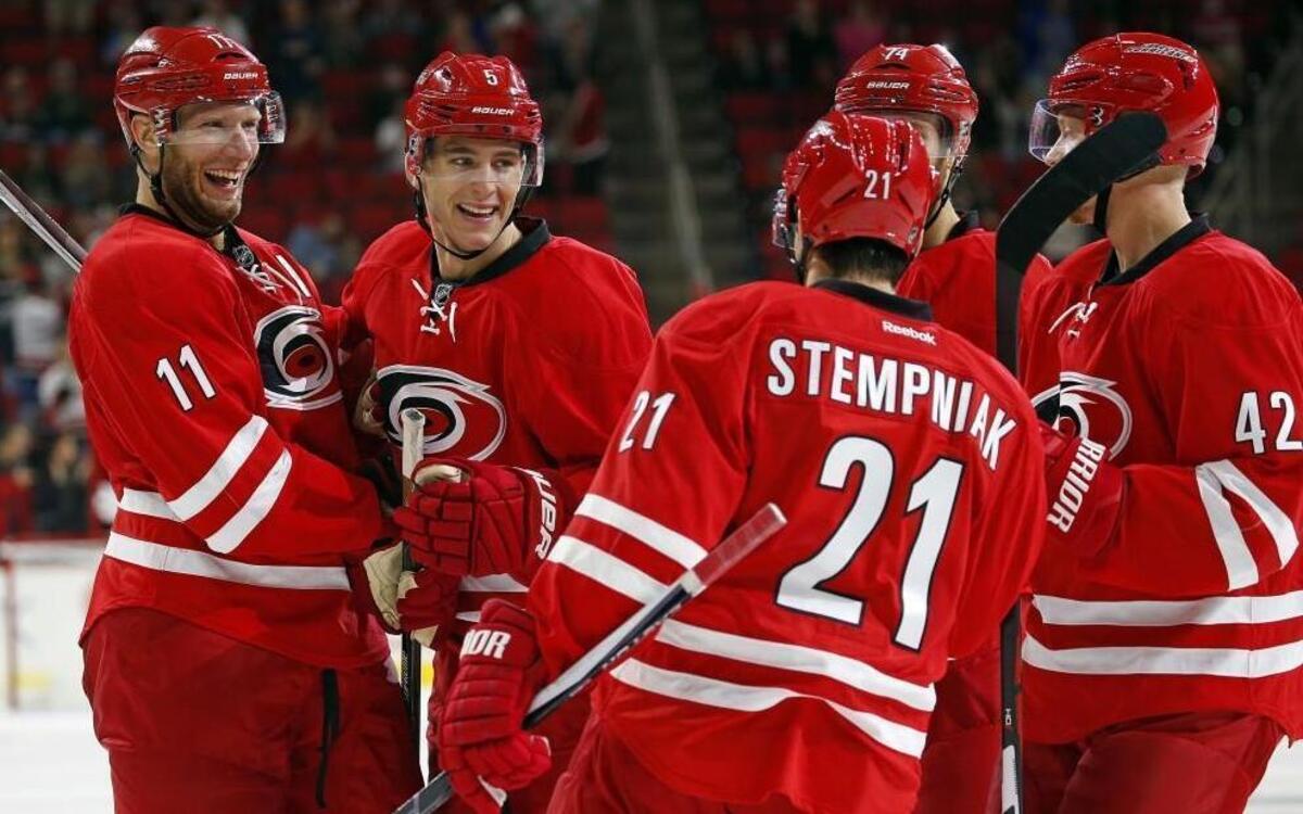Carolina Hurricanes' Jordan Staal (11), Noah Hanifin (5), Jaccob Slavin (74) and Joakim Nordstrom (42) congratulate Lee Stempniak (21) on his goal during the second period of an NHL preseason hockey game against the Washington Capitals.