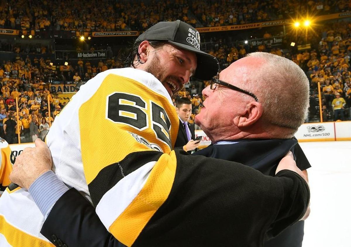 General Manager Jim Rutherford of the Pittsburgh Penguins hugs Ron Hainsey after Game 6 of the 2017 NHL Stanley Cup Final at the Bridgestone Arena.