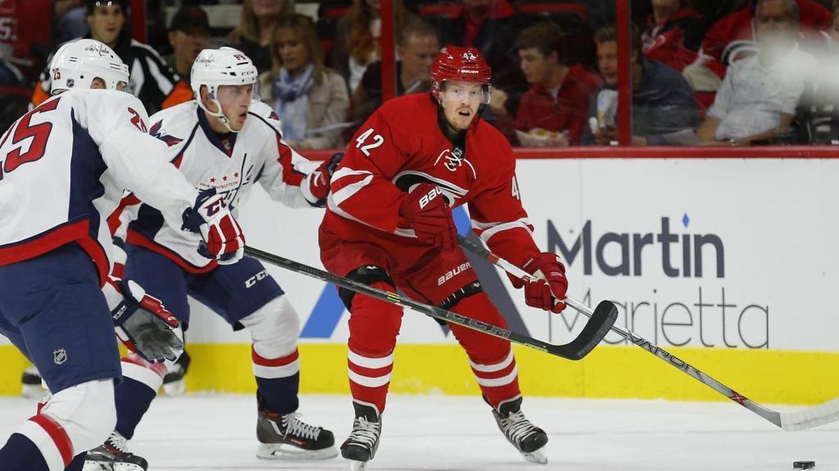 
The Hurricanes’ Joakim Nordstrom (42) moves the puck against the Capitals’ Jason Chimera (25) and Nate Schmidt (88) during the first period of Carolina’s preseason game against Washington on Wednesday at PNC Arena in Raleigh. The Canes beat the Capitals 4-3 in a shootout.
