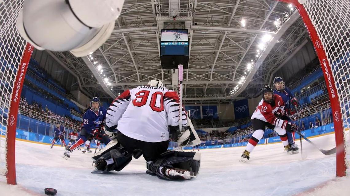 The puck shot by South Korea's Randi Heesoo Griffin (37), of the combined Koreas team, sails past goalie Akane Konishi (30), of Japan, during the second period of the preliminary round of the women's hockey game at the 2018 Winter Olympics in Gangneung, South Korea, on Feb. 14, 2018. Griffin is from Apex and attends Duke. (Bruce Bennett/Pool Photo via AP)
