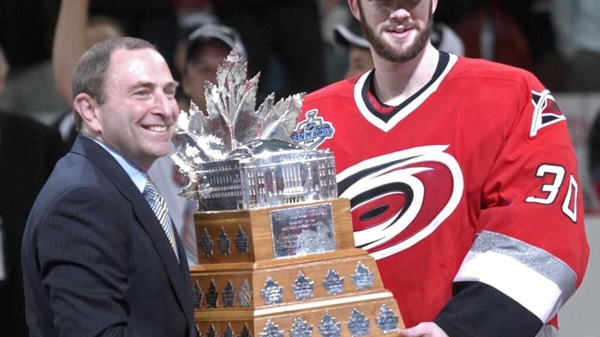 NHL Commissioner Gary Bettman, left, present the Canes Cam Ward with the Conn Smyth trophy after the Carolina Hurricanes beat the Edmonton Oilers in Game 7 of the Stanley Cup at the then RBC Center on June 19, 2006.