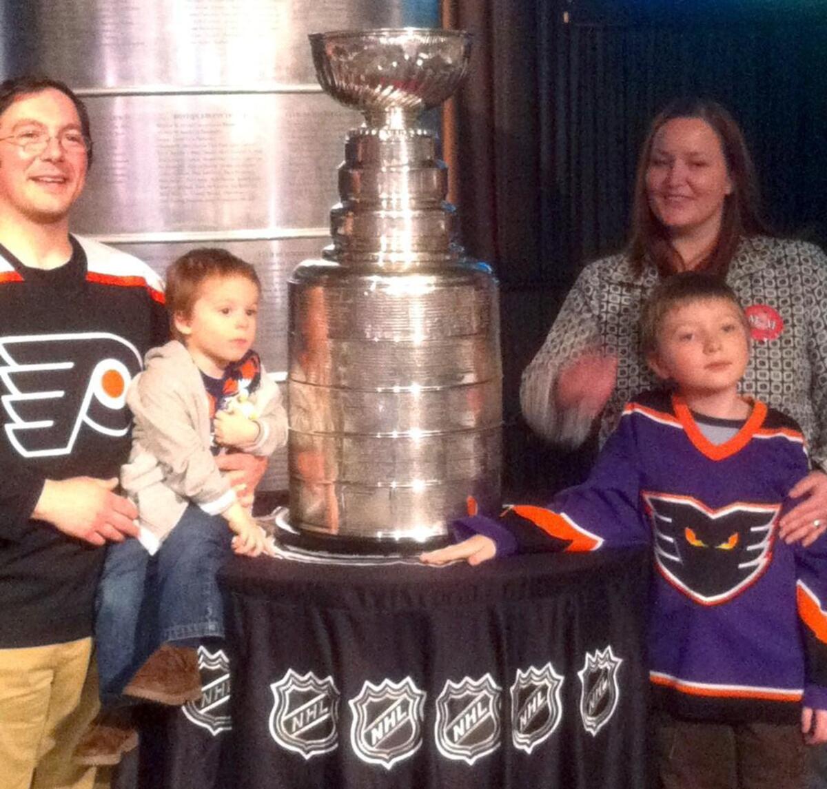 Lucas Pennachi, right, his younger brother Victor and parents Matt and Miranda pose with the Stanley Cup at the Raleigh Convention Center during festivities surrounding the NHL All Star Game Jan. 29, 2011.