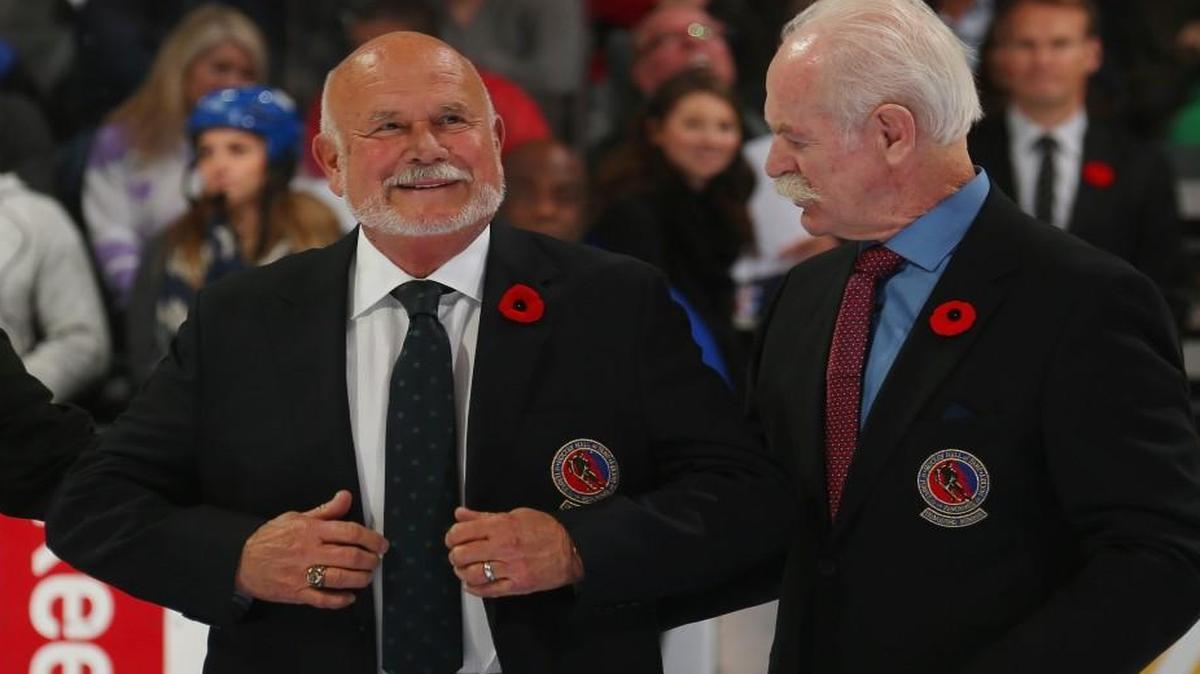 Peter Karmanos Jr., left, receives his Hockey Hall of Fame blazer from the Chairman of the Hockey Hall of Fame Lanny McDonald prior to the Legends Classic game on November 8, 2015 at the Air Canada Centre in Toronto, Ontario, Canada. The Hall induction ceremony is slated for November 9.