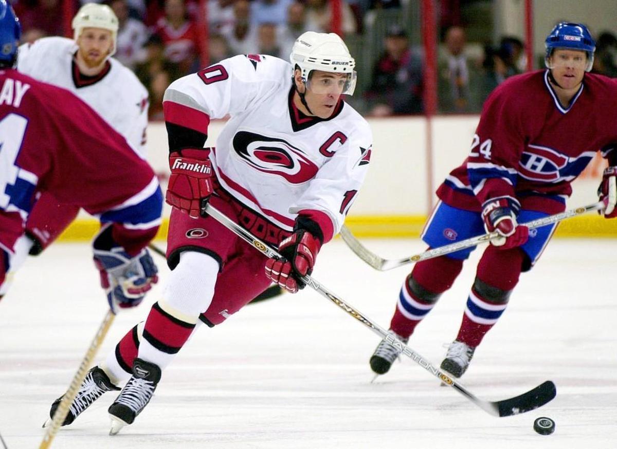 Carolina Hurricanes (10) Ron Francis work his way between Montreal's (44) Sheldon Souray, and (24) Andreas Dackell on May 3, 2002 at the Entertainment & Sports Arena during the second round of the Stanley Cup playoffs.