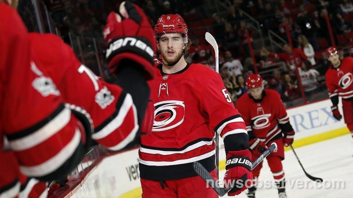 The Canes' Noah Hanifin (5) celebrates his goal as he come back to the bench.
