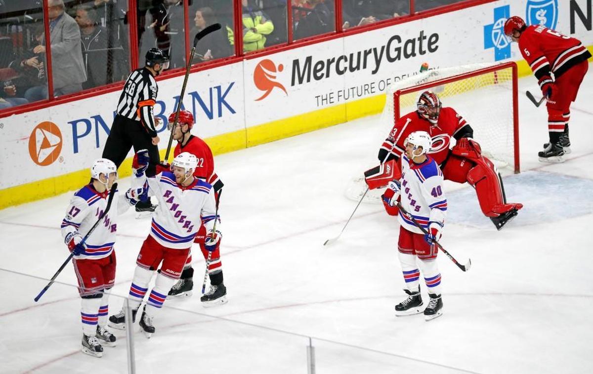 The Rangers' Jesper Fast (17) celebrates his goal with Steven Kampfer (47) and Michael Grabner (40) during the third period of an NHL game played between the Carolina Hurricanes and the NY Rangers at PNC Arena in Raleigh, N.C. on Nov. 22, 2017. Dejected Hurricanes are Brett Pesce (22), Scott Darling (33) and Noah Hanifin (5). The Rangers beat the Hurricanes 6-1.