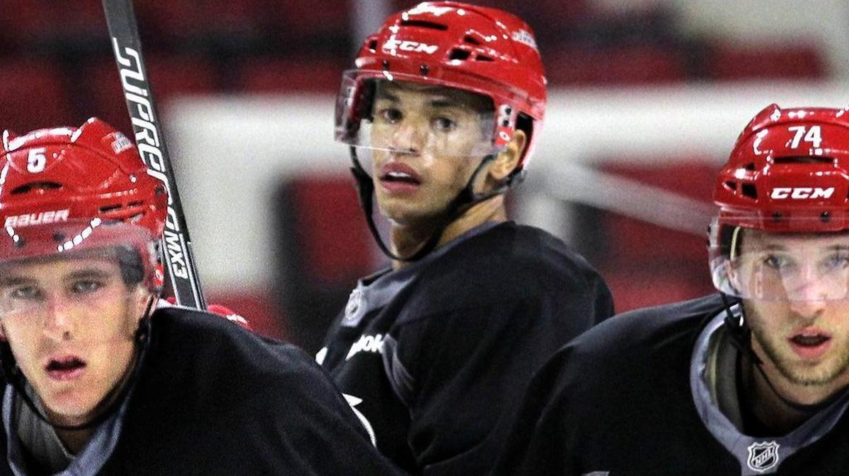 Noah Hanifin (5), left, Trevor Owens (84), center, and Jaccob Slavin (74) watch a drill during the Carolina Hurricanes development camp for NHL prospects held at PNC Arena last July.
