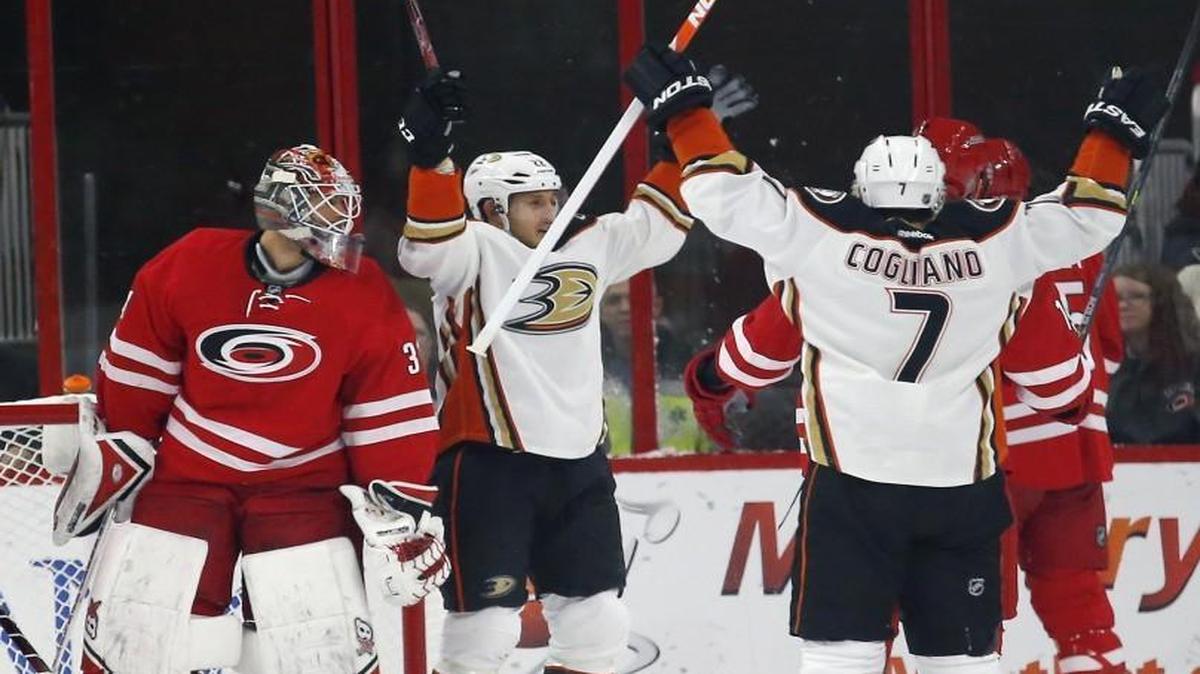 Shawn Horcoff (22) celebrates his goal with Andrew Cogliano (7) after he scored against the Canes’ Justin Faulk (27) and goalie Eddie Lack during the first period at PNC Arena in Raleigh.
