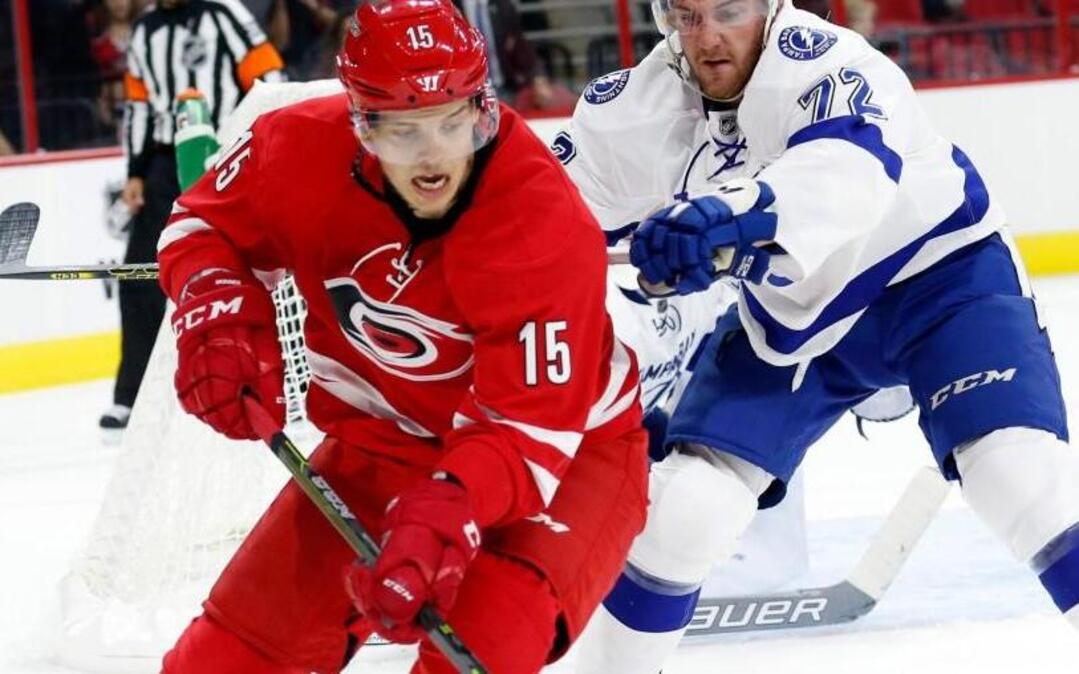 The Canes’ Andrej Nestrasil (15) battles the Tampa Bay Lightning's Dylan Blujus for the puck during a NHL preseason game at PNC Arena in Raleigh on Sept. 30, 2016.