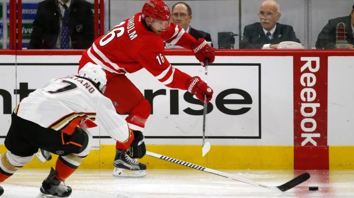 The Canes' Elias Lindholm (16) moves the puck against the Anaheim Ducks' Andrew Cogliano (7) during the second period of an NHL game played between the Carolina Hurricanes and the Anaheim Ducks at the PNC Arena in Raleigh, N.C. on Nov. 10, 2016.