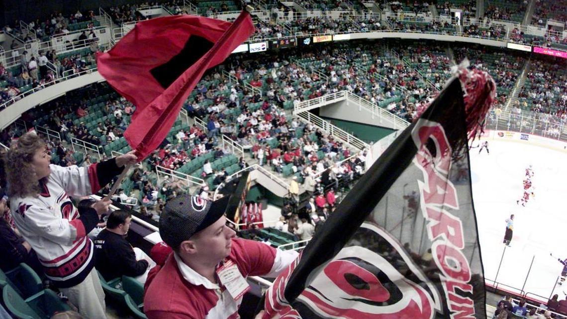 Hurricanes fans Shawn Williams (left) of Chapel Hill, and Sam Walker (right) of Dunn, N.C. wave their flags during the second period of the final game of the Inaugural season in the Greensboro Coliseum April 18, 1998.