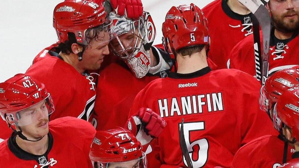 The Canes Ron Hainsey (65) and Cam Ward (30) embrace as the players celebrate at the conclusion of an NHL game played between the Carolina Hurricanes and the Montreal Canadiens at PNC Arena in Raleigh, N.C. on Nov. 18, 2016. The Canes beat the Canadiens 3-2.
