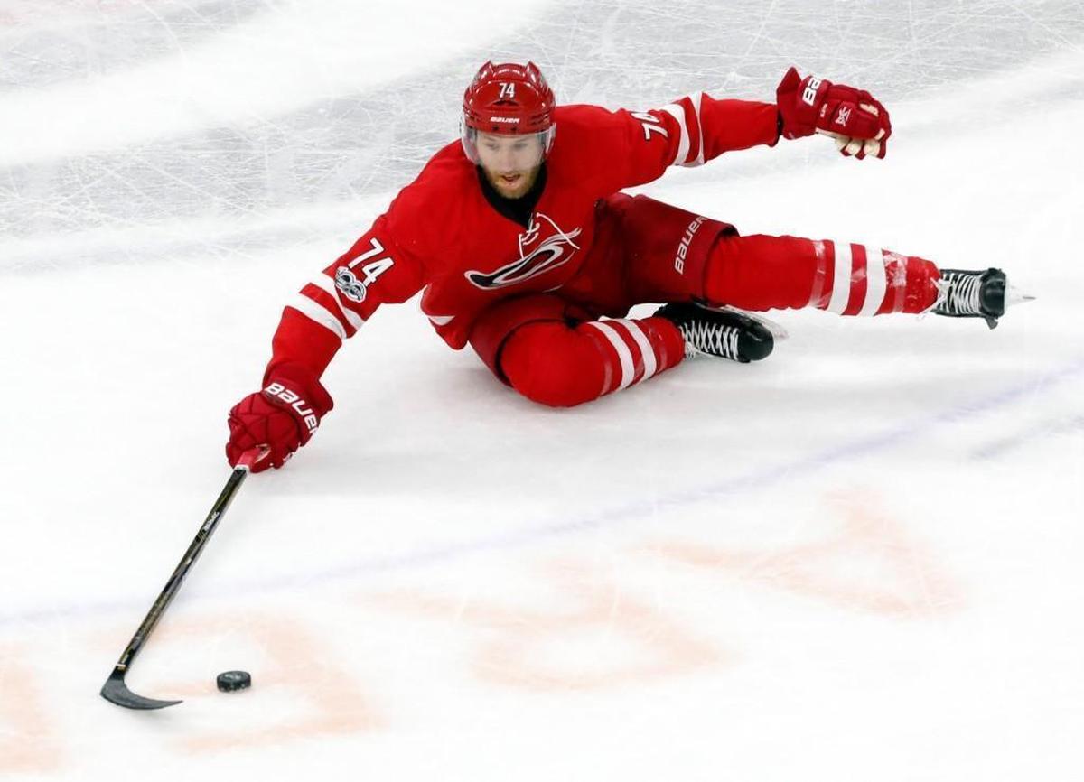 The Canes' Jaccob Slavin (74) dives for the puck during game against the the St. Louis Blues at PNC Arena on April 8, 2017.