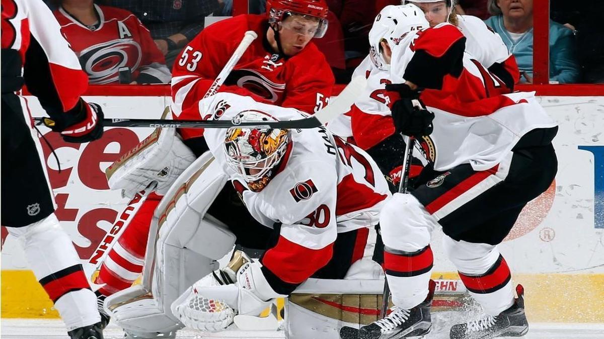 Carolina Hurricane Jeff Skinner (53) pressures Ottawa Senator goalie Andrew Hammond as they search for a loose puck at PNC Arena in Raleigh.