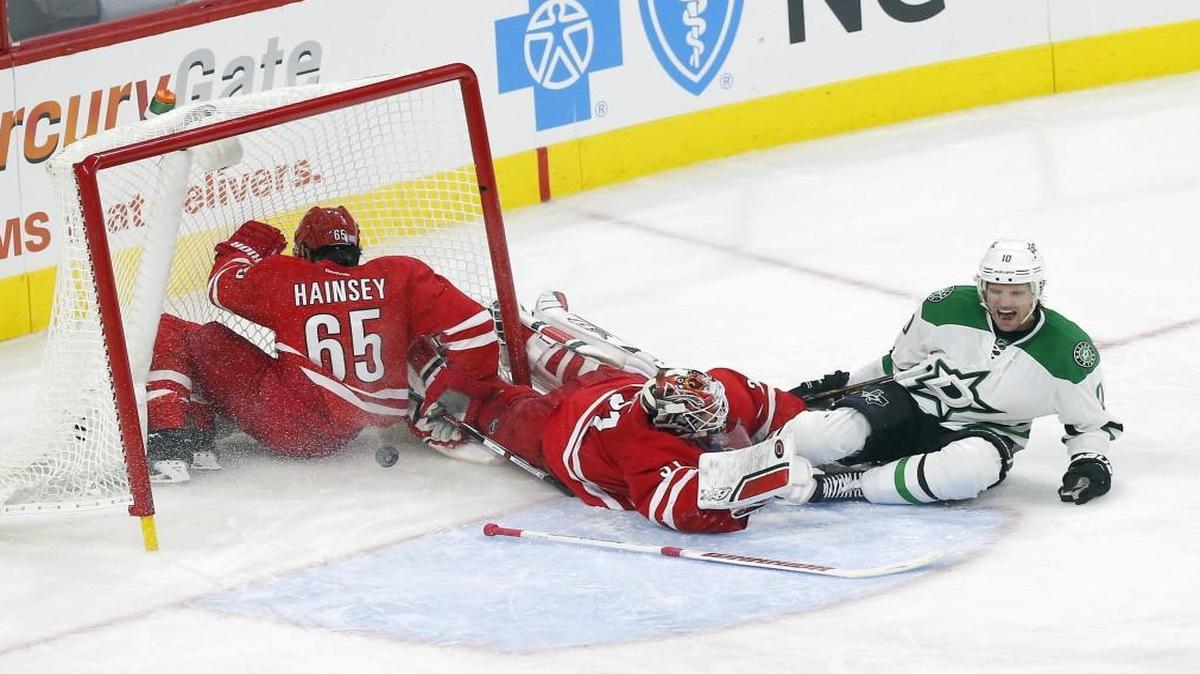 The Dallas Stars' Patrick Sharp (10) lets out a yell after scoring against the Canes’ Ron Hainsey (65) and Eddie Lack (31) during the third period of an NHL game played between the Carolina Hurricanes and the Dallas Stars at PNC Arena in Raleigh, N.C. on Nov. 6, 2015. It proved to be the game-winning goal. The Starts beat the Canes 4-1.