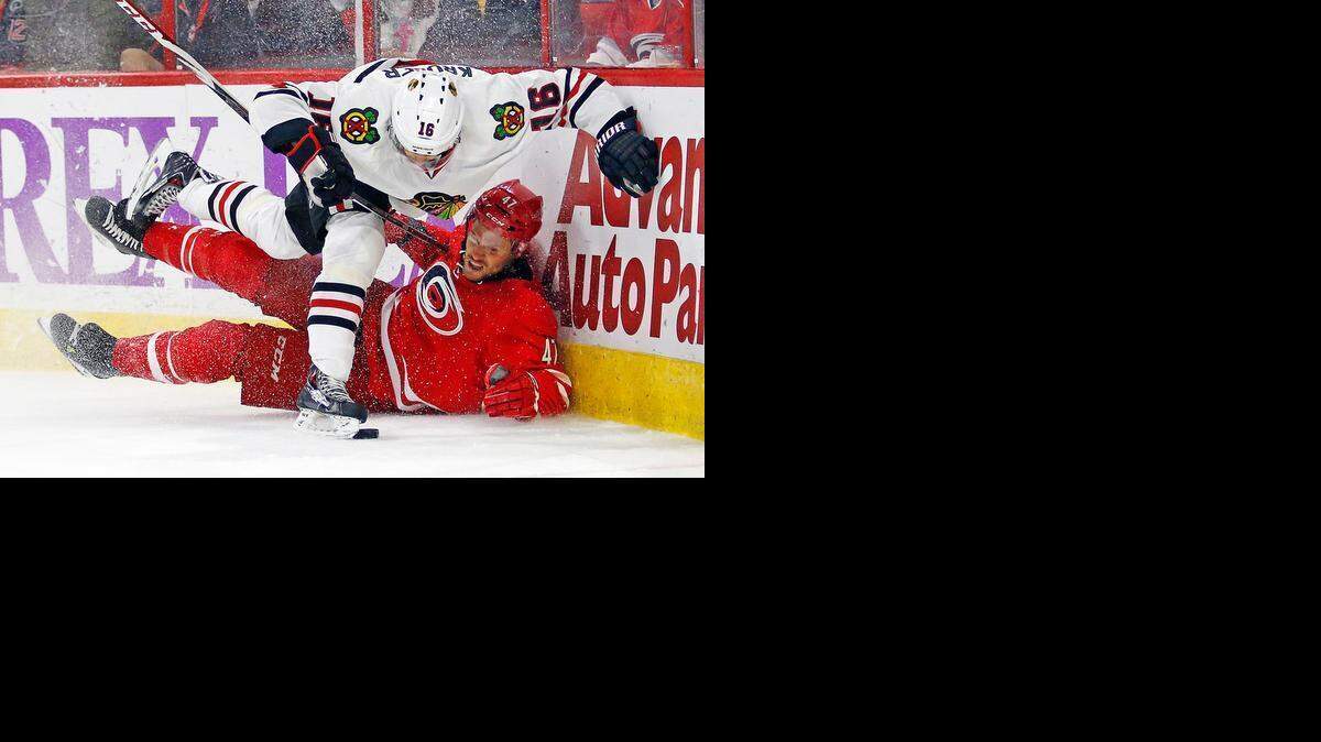 
Chicago Blackhawks' Marcus Kruger (16) collides with Carolina Hurricanes' Michal Jordan (47), of the Czech Republic, during the first period of an NHL hockey game Monday, March 23, 2015, in Raleigh, N.C. 
