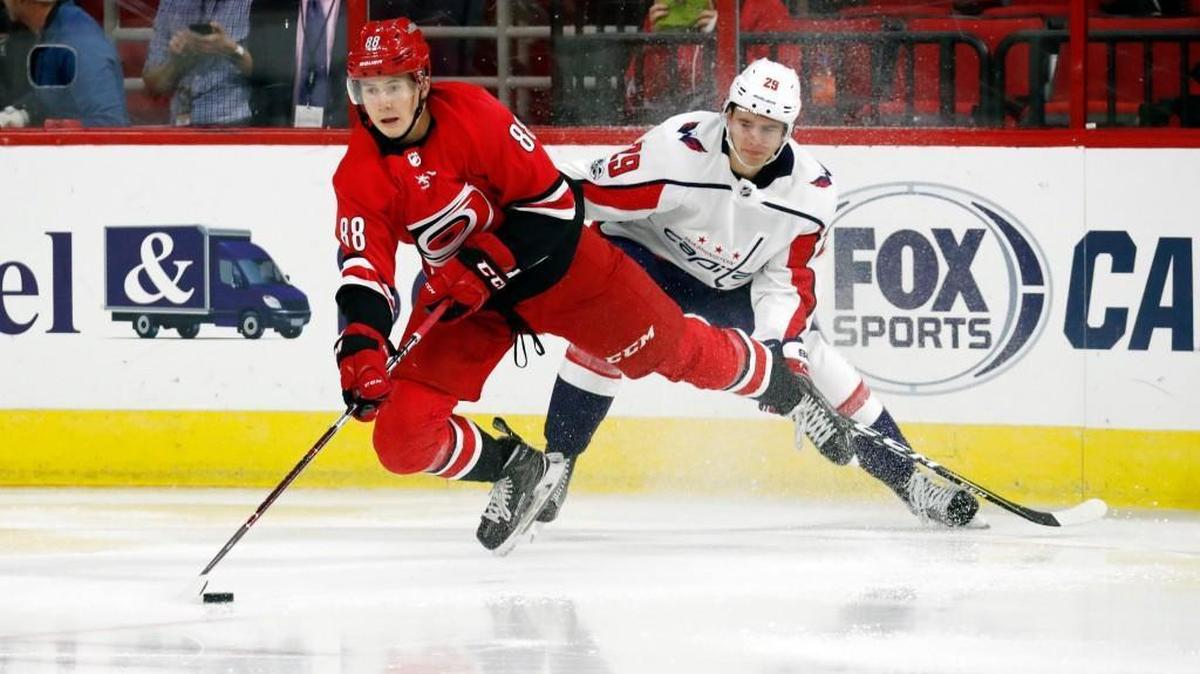 The Canes' Martin Necas (88) battles the Caps' Madison Bowey (22) for the puck during the second period of a preseason NHL game played between the Carolina Hurricanes and the Washington Capitals at PNC Arena on Sept. 29, 2017.