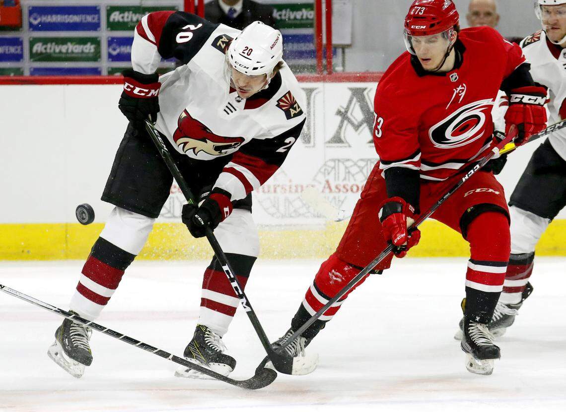 The Canes’ Valentin Zykov (73) and the Coyotes’ Dylan Strome (20) battle puck during 2018 game at PNC Arena.