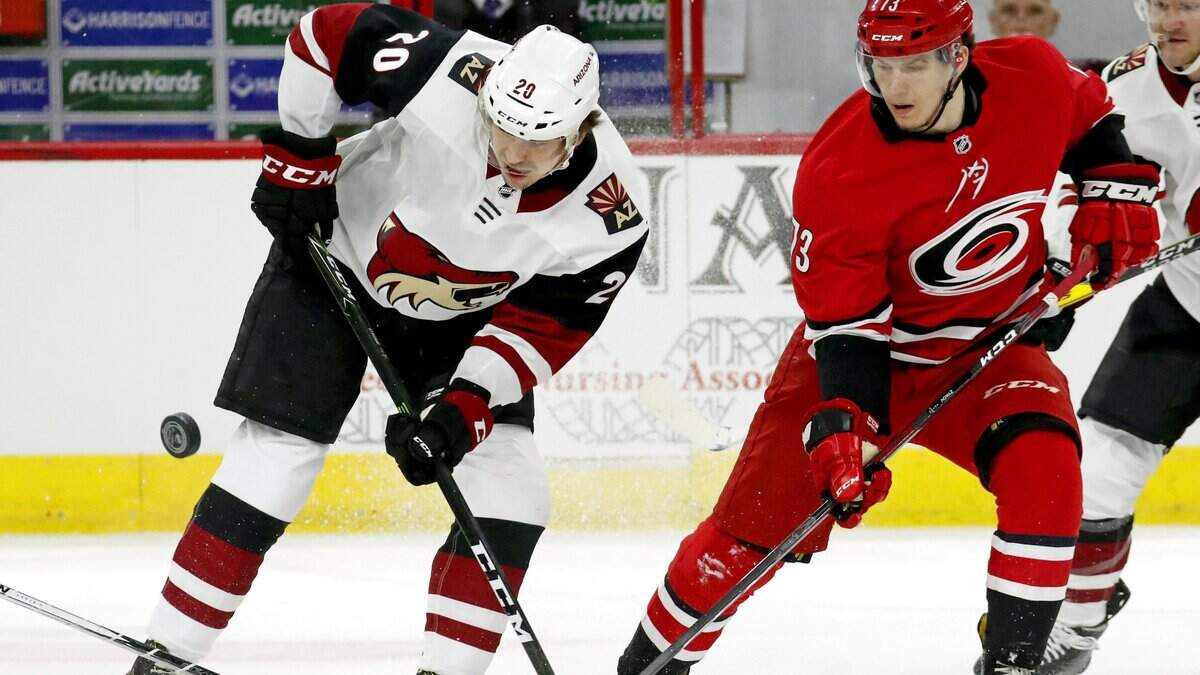 The Canes’ Valentin Zykov (73) and the Coyotes’ Dylan Strome (20) battle puck during 2018 game at PNC Arena.