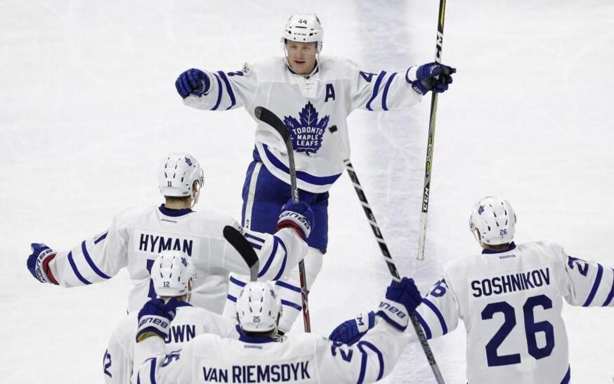 Toronto Maple Leafs' Morgan Rielly (44) celebrates his game-winning goal in overtime against the Carolina Hurricanes with Zach Hyman, Curtis McElhinney (35) and Nikita Soshnikov (26).