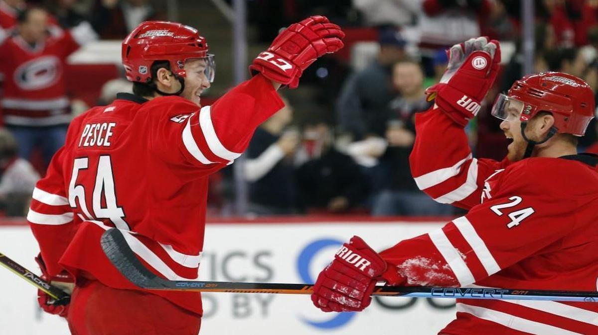 The Canes’ Brett Pesce (54) celebrates his goal against the Los Angeles Kings with Brad Malone (24) during the first period at PNC Arena in Raleigh. It was Pesce’s first NHL goal.