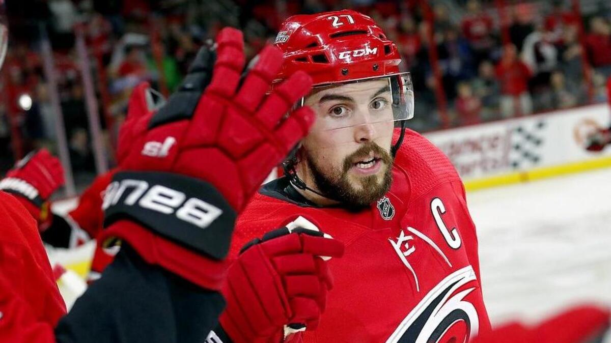 The Canes' Justin Faulk (27) celebrates his third goal of the night as he comes back to the bench during the second period of an NHL game played between the Carolina Hurricanes and the L.A. Kings at PNC Arena in Raleigh, N.C. on Feb. 13, 2018.