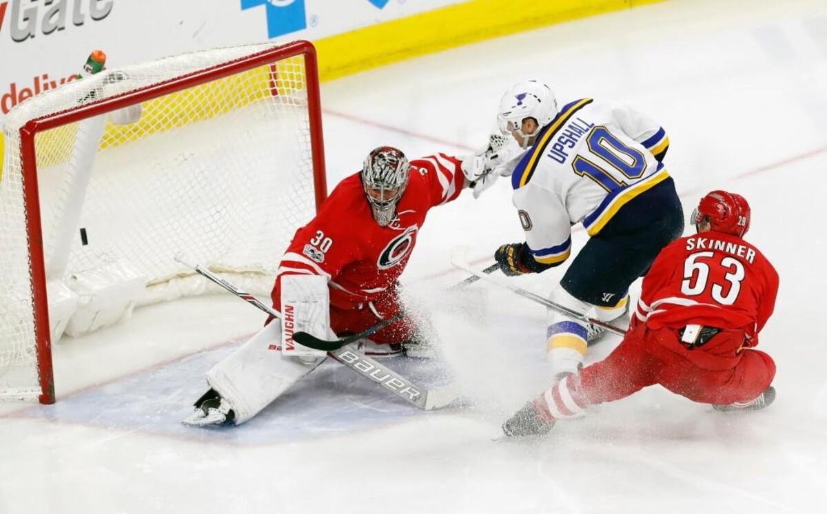 The St. Louis Blues' Scottie Upshall (10) scores a goal against the Canes' Jeff Skinner (53) and Cam Ward (30) at PNC Arena in Raleigh on April 8, 2017.