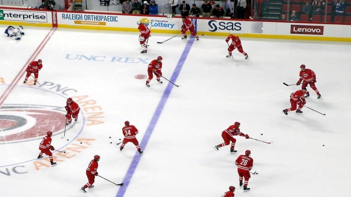 The Carolina Hurricanes, right, skate during warm-ups before an NHL preseason game played between the Carolina Hurricanes and the Tampa Bay Lightning at the PNC Arena in Raleigh, N.C. on Sept. 30, 2016.