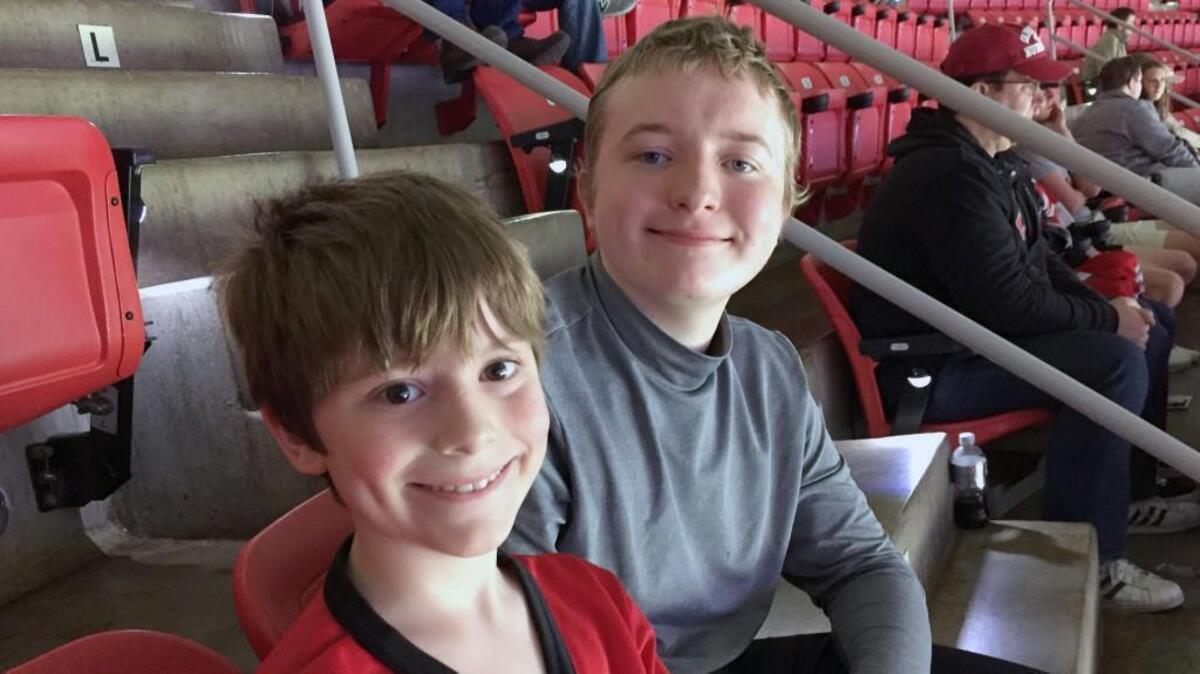 Lucas Pennachi, right, and younger brother Victor at a Hurricanes game in PNC Arena in April 2017.