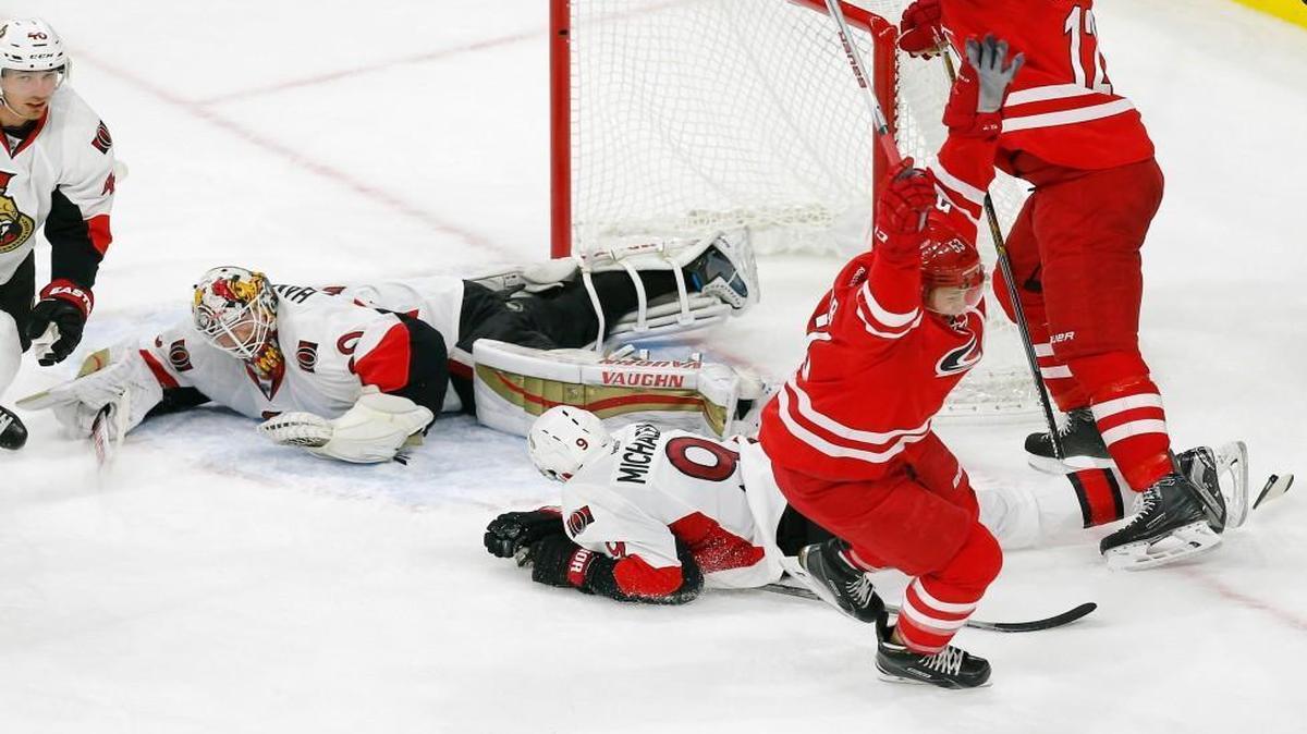 The Canes’ Jeff Skinner (53) celebrates after scoring in the final seconds to tie the game with the Ottawa Senators as Eric Staal (12) looks onSenators goalie Andrew Hammond (30) and Milan Michalek (9) are in on the play.