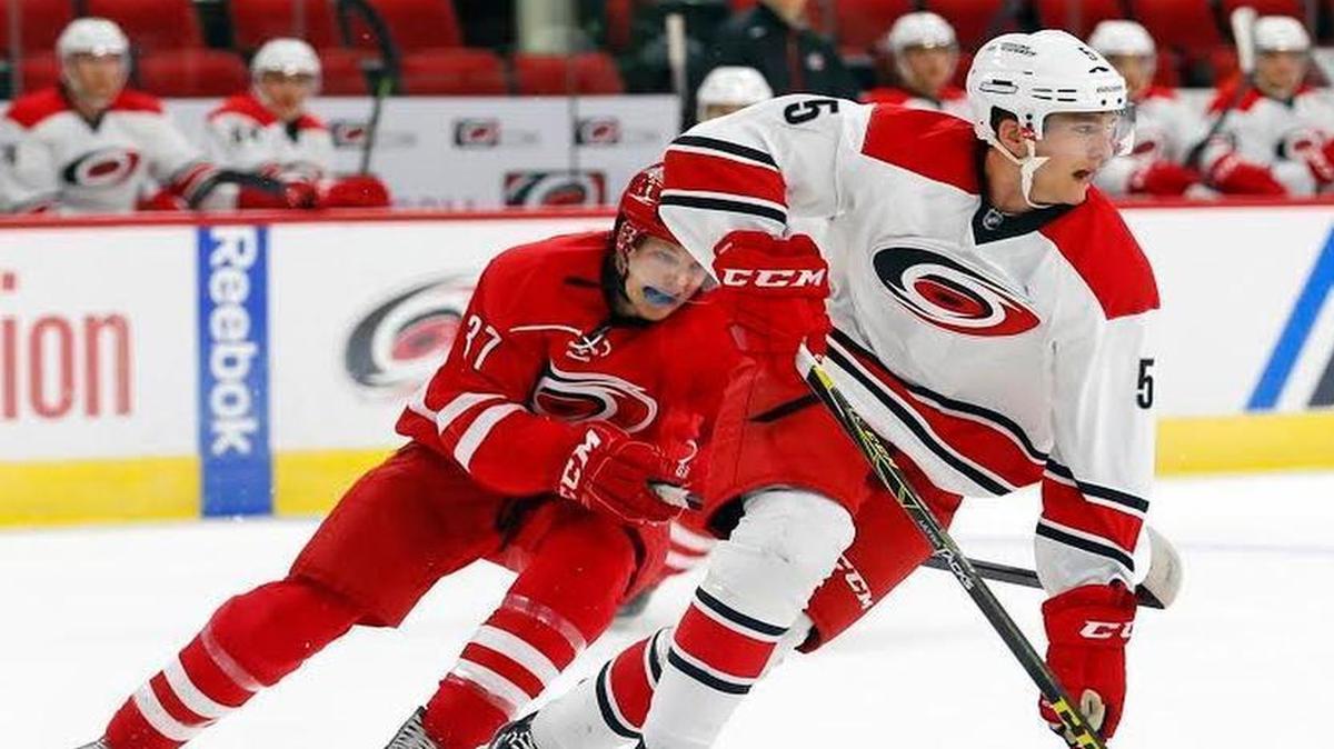 
Noah Hanifin (5) moves the puck against Warren Foegele (37) as the Carolina Hurricanes hold a training camp for NHL prospects at PNC Arena in Raleigh on July 7, 2015. Hanifin was the Canes 2015 first-round draft pick and signed a three-year contract Saturday, July 11, 2015.
