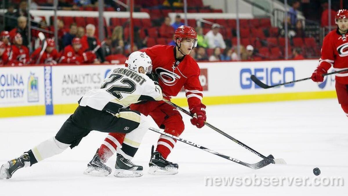 
The Carolina Hurricanes' Noah Hanifin (5) moves the puck against the Pittsburgh Penguins' Patric Hornqvist (72) during the first period.
