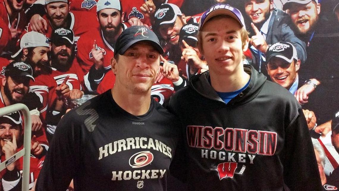 Carolina Hurricanes then-assistant coach and captain of the 2006 Stanley Cup championship team Rod Brind’Amour, left, and his son Skyler Brind’Amour pose in front of a mural of the 2006 team at PNC Arena on June 13, 2016.