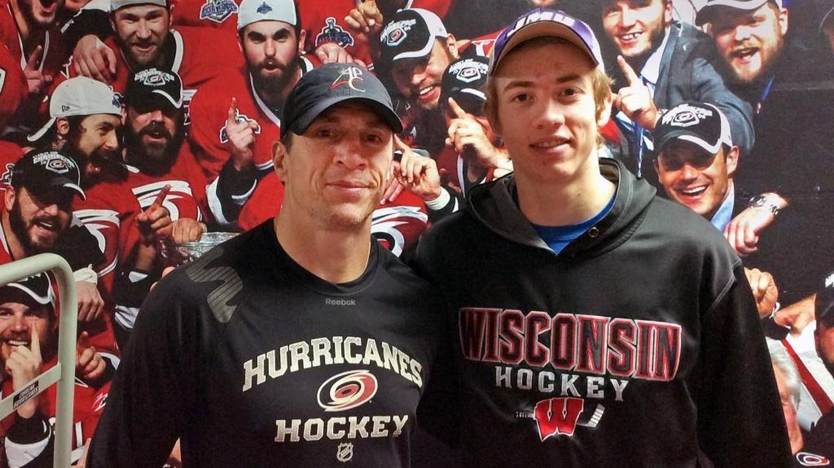 Carolina Hurricanes assistant coach and captain of the 2006 Stanley Cup championship team Rod Brind’Amour, left, and his son Skyler Brind’Amour pose in front of a mural of the 2006 team at PNC Arena on June 13, 2016.