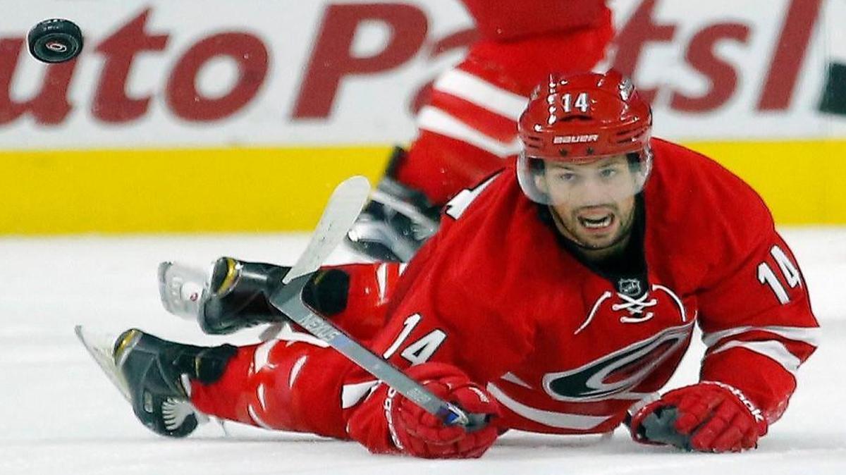 The Carolina Hurricanes' Nathan Gerbe (14) keeps his eye on the puck as he dives to make a play during their game against the Florida Panthers at PNC Arena in Raleigh on Oct. 13, 2015.