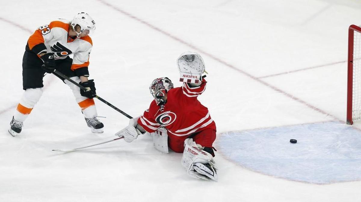 The Philadelphia Flyers' Jakub Voracek scores the winning goal against Canes goalie Cam Ward during the overtime period at PNC Arena in Raleigh.
