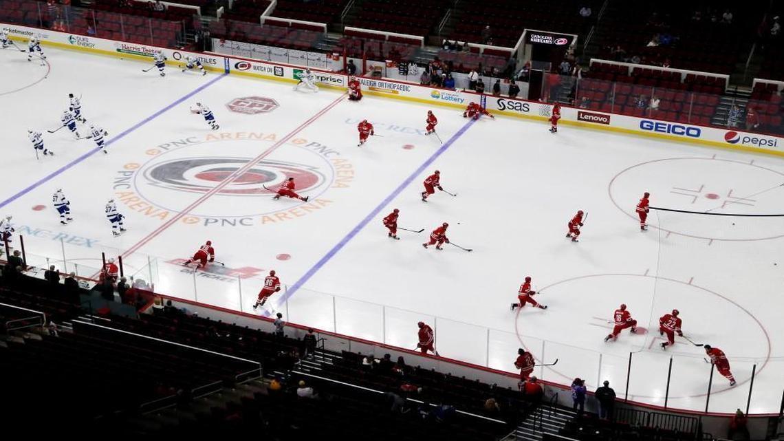 The Carolina Hurricanes, right, skate during warm-ups before an NHL preseason game against the Tampa Bay Lightning at the PNC Arena in Raleigh on Sept. 30, 2016.