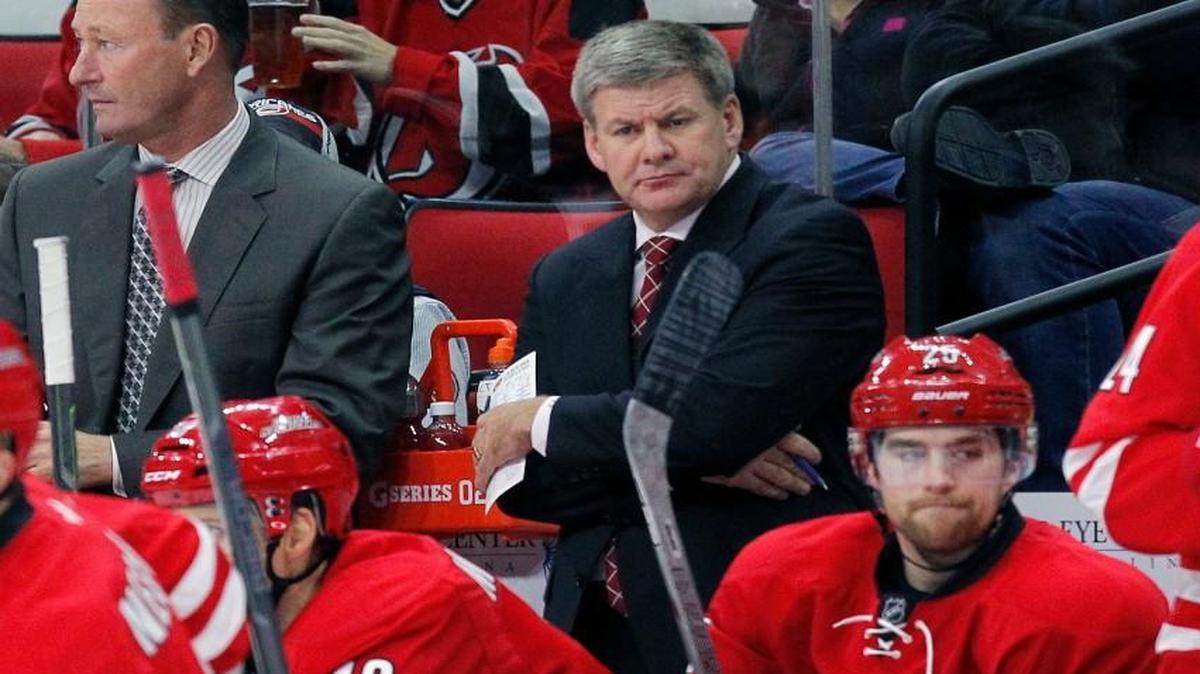 Canes coach Bill Peters watches the action against New Jersey during the second period at PNC Arena in Raleigh.