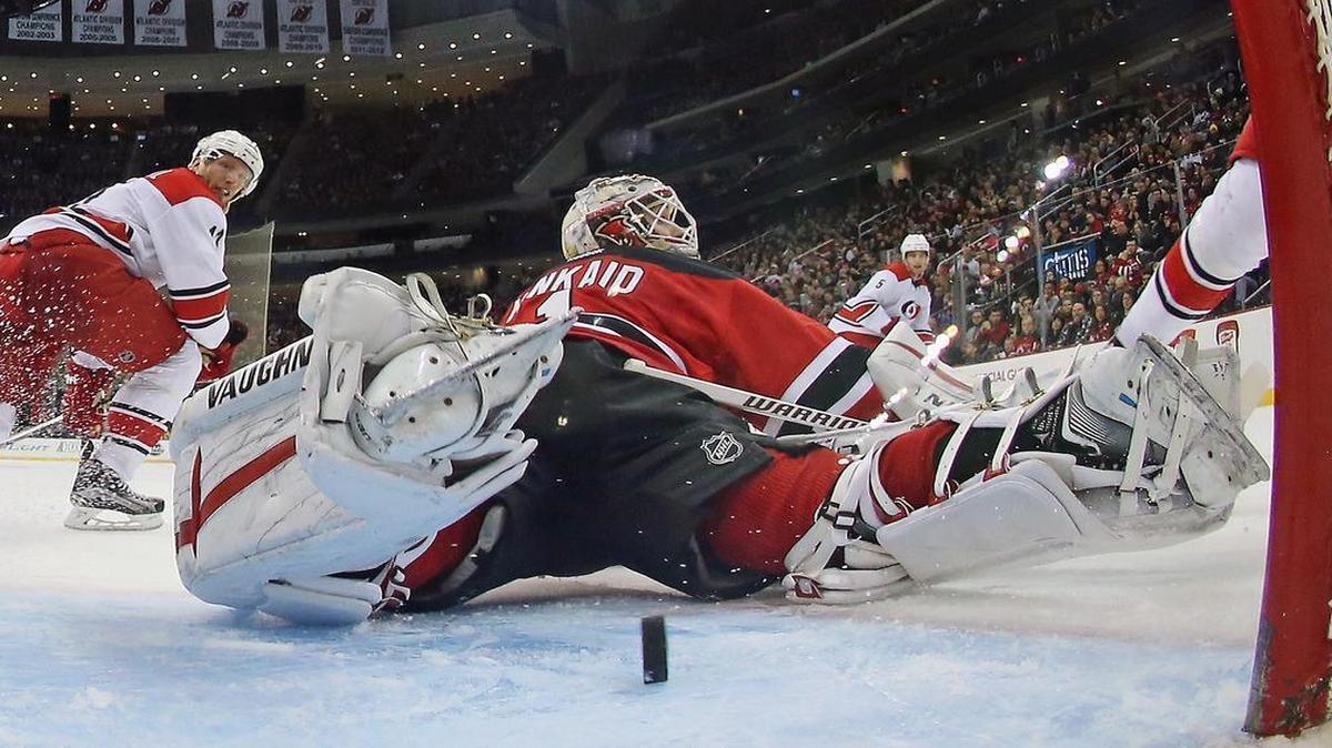 The puck gets behind Keith Kinkaid (1) of the New Jersey Devils during the second period against the Carolina Hurricanes at the Prudential Center on December 29, 2015 in Newark, N.J.