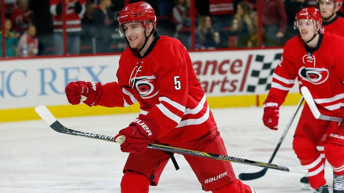 The Canes Noah Hanifin (5) celebrates goal with Joakim Nordstrom (42) and Victor Rask (49) as he comes to the bench after he scored during the second period of an NHL game played between the Carolina Hurricanes and the Anaheim Ducks at PNC Arena in Raleigh, N.C. on Nov. 16, 2015. It was his first NHL goal.