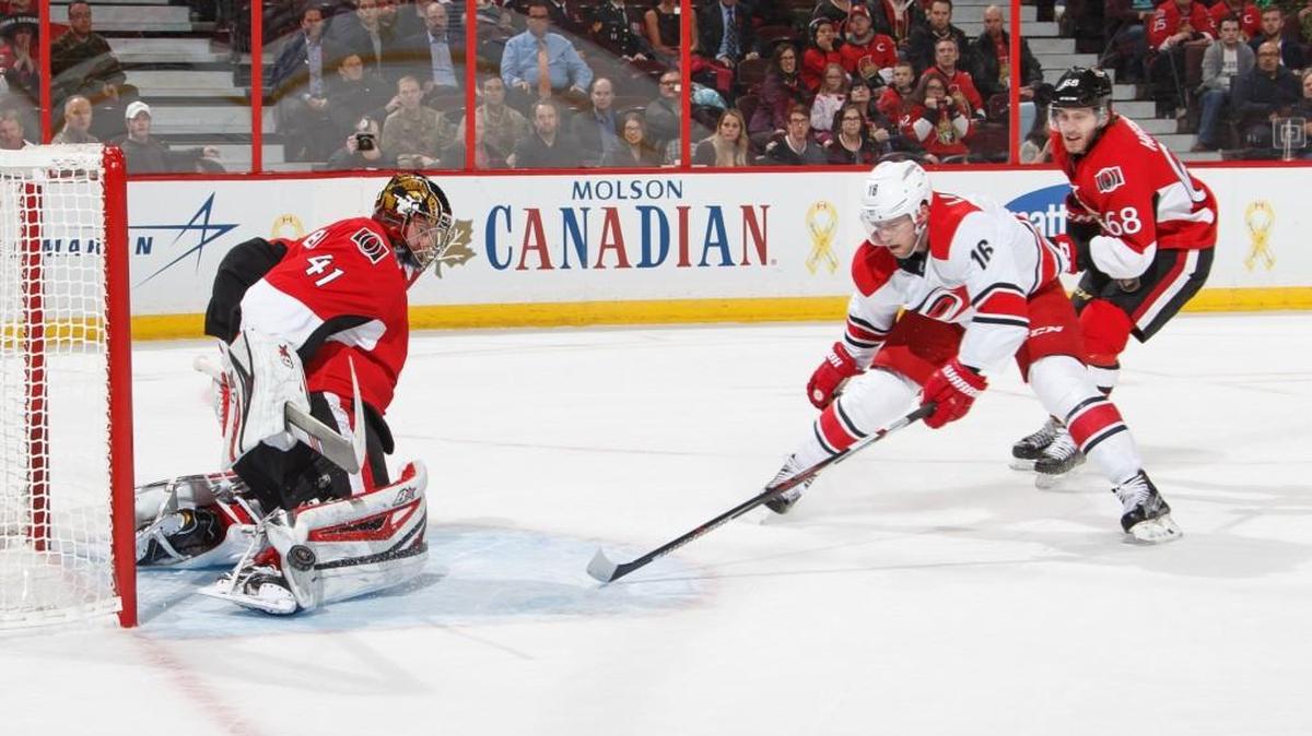 Craig Anderson #41 of the Ottawa Senators makes a save against Elias Lindholm #16 of the Carolina Hurricanes in overtime as Mike Hoffman #68 back checks on the scoring chance at Canadian Tire Centre on Tuesday in Ottawa. (Photo by Andre Ringuette/NHLI via Getty Images)