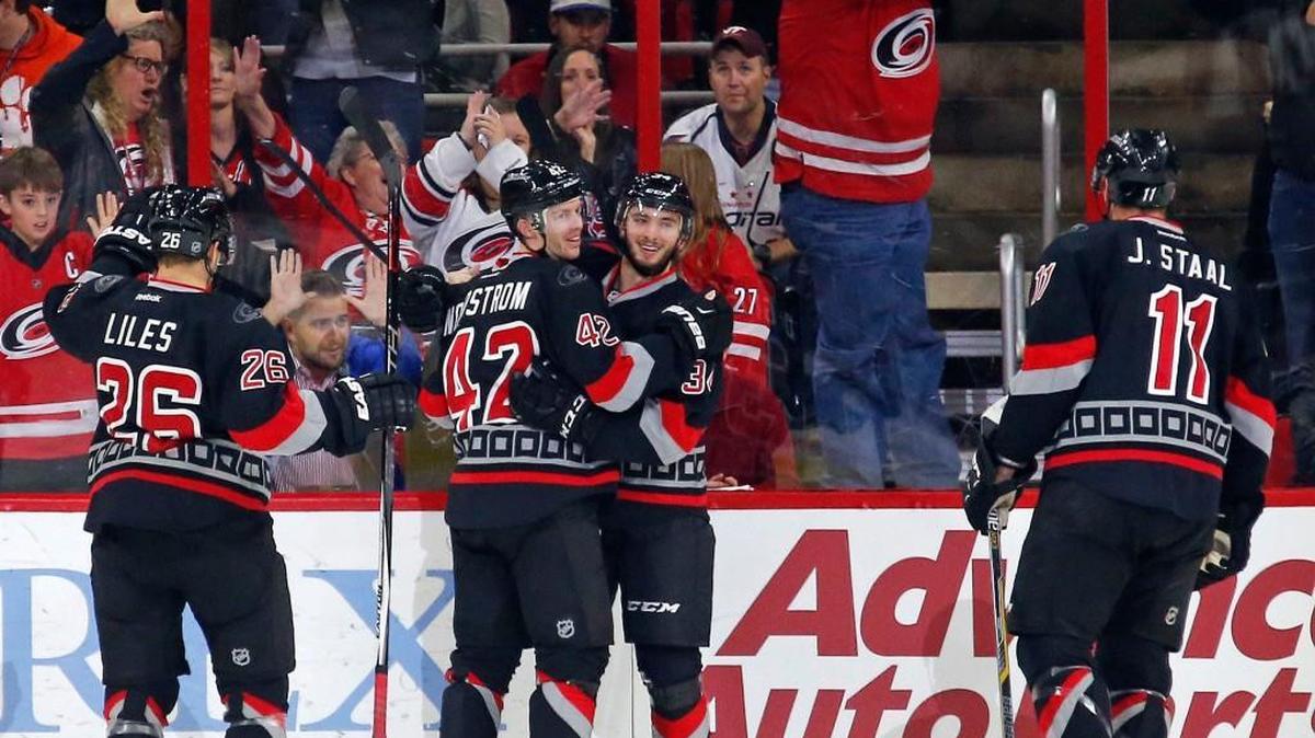The Carolina Hurricanes' Phil Di Giuseppe (34) celebrates his goal with John-Michael Liles (26), Joakim Nordstrom (42) and Jordan Staal (11) during the second period of an NHL game played between the Carolina Hurricanes and the Washington Capitals at PNC Arena in Raleigh, N.C. on Dec. 31, 2015.