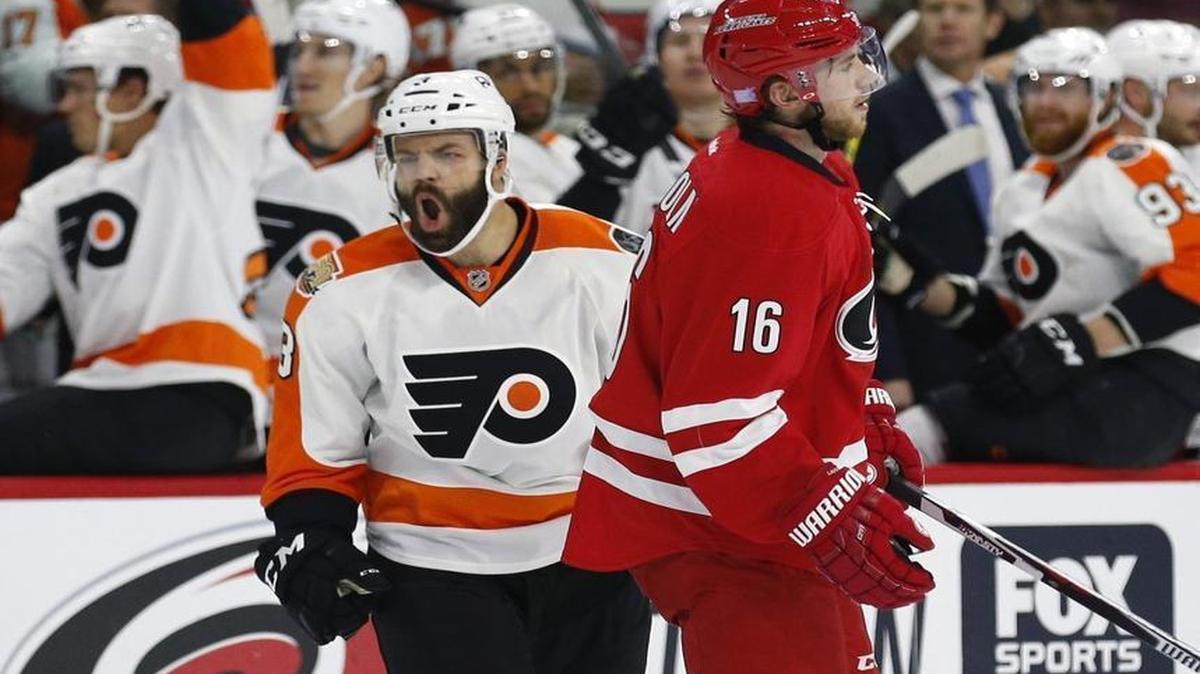 The Philadelphia Flyers' Radko Gudas (3) celebrates his goal during the second period against the Carolina Hurricanes at PNC Arena in Raleigh. The Canes' Elias Lindholm (16) skates away.