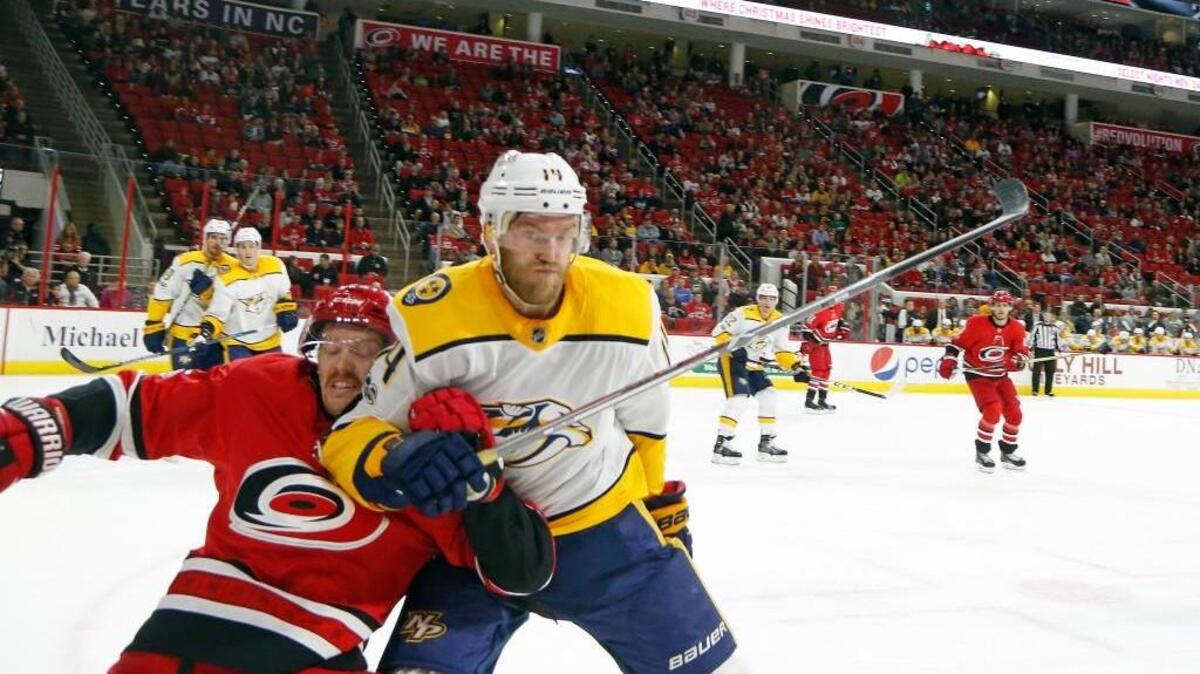 The Canes' Joakim Nordstrom (42) battles the Predators' Mattias Ekholm (14) during the second period of an NHL game played between the Carolina Hurricanes and the Nashville Predators at PNC Arena in Raleigh, N.C. on Nov. 26, 2017. The Canes beat the Predators 4-3 in a shootout.